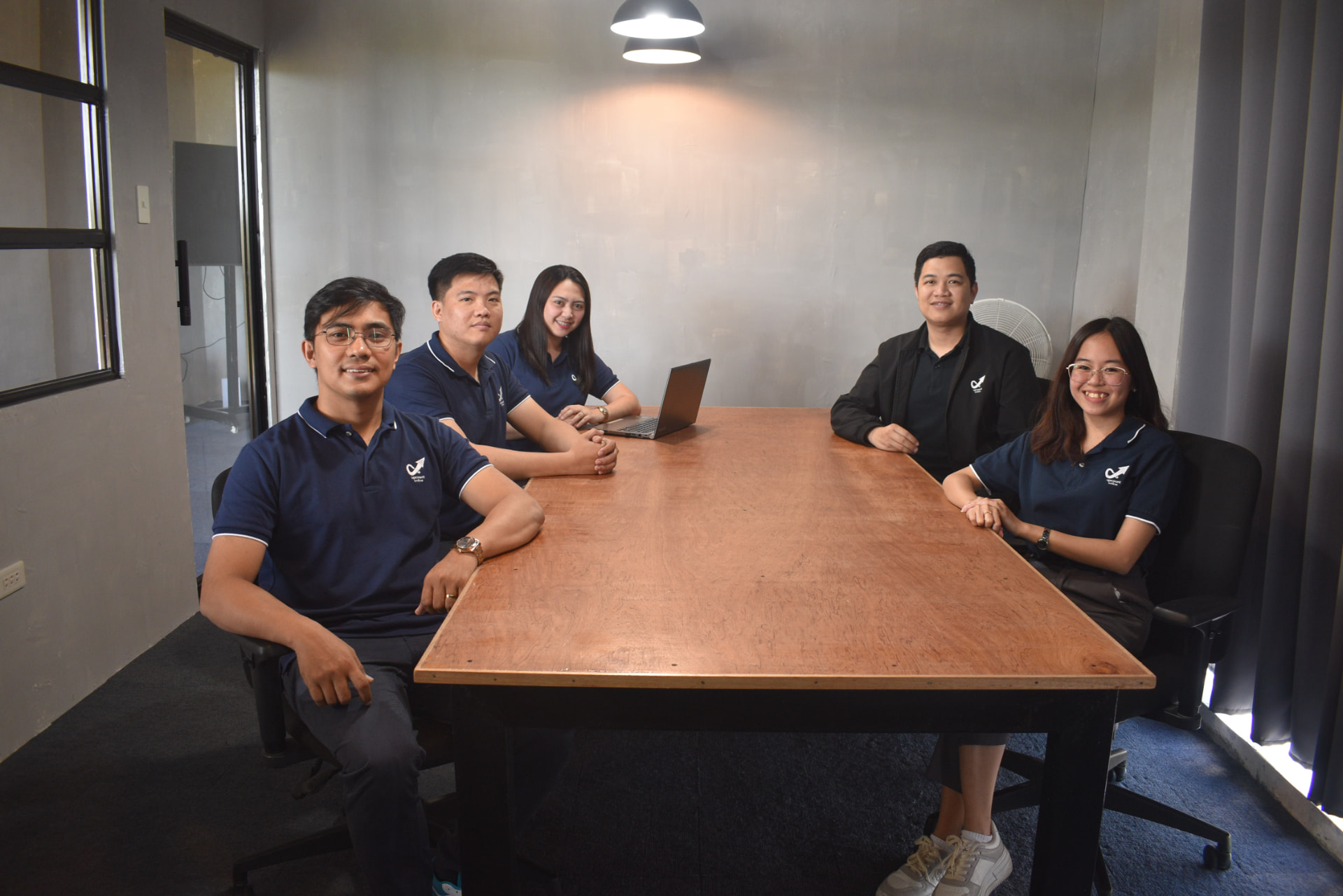 Upcount Online team seated together in the meeting room